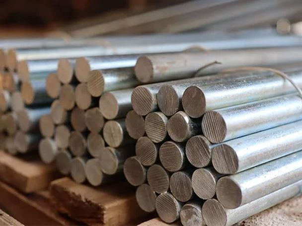 A close up shot showing galvanised round dowel bar stacked and tied on a pallets.